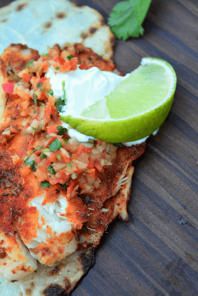 Kidney friendly smoky blackened tilapia with red pepper pico de gallo, lime, and sour cream