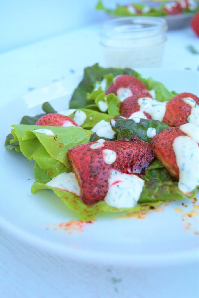 low potassium strawberrie and greens salad on plate with low phosphorus creamy dressing for kidney diet