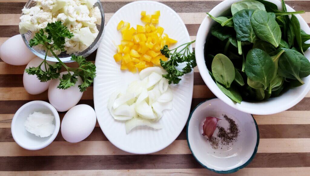 renal diet breakfast ingredients for loaded veggie eggs on striped cloth