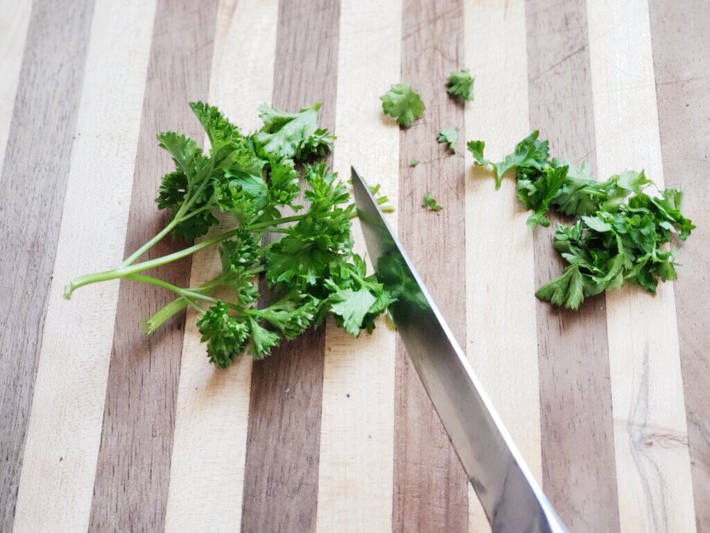 parsley chopped on striped cutting board for renal diet breakfast recipe