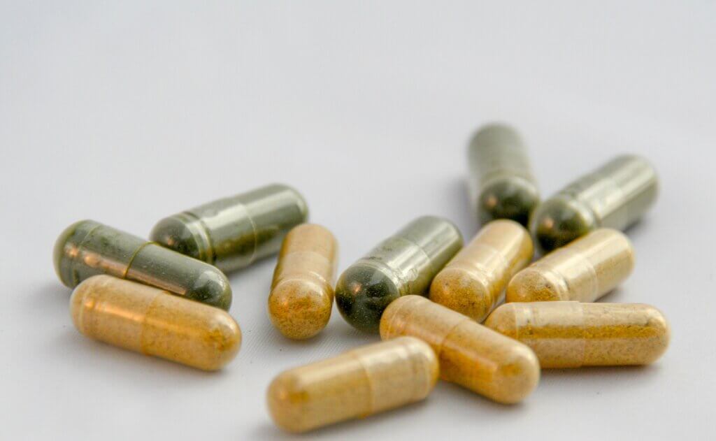 green and yellow pill capsules as example of probiotics for kidneys
