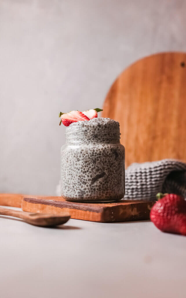 Close up view chia pudding with spoon on wooden board
