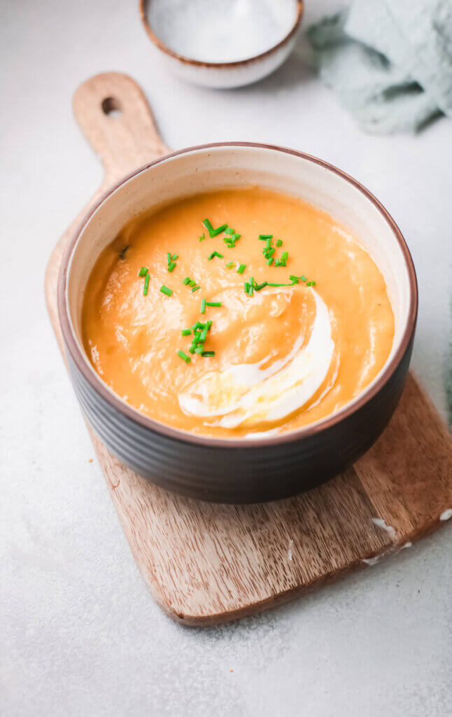 Creamy carrot soup on wooden board-kidney friendly