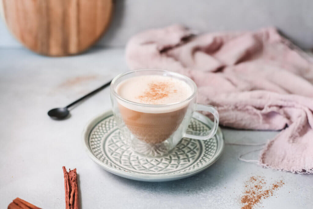 Molasses milk with spoon and cinnamon stick-kidney friendly