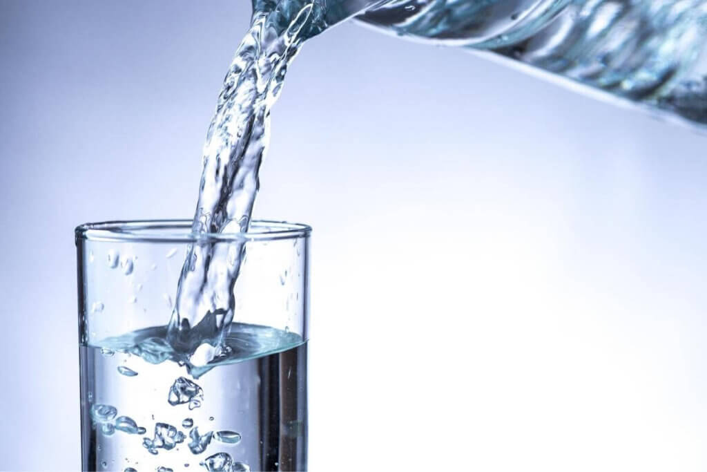 Pouring water from a bottle into a glass