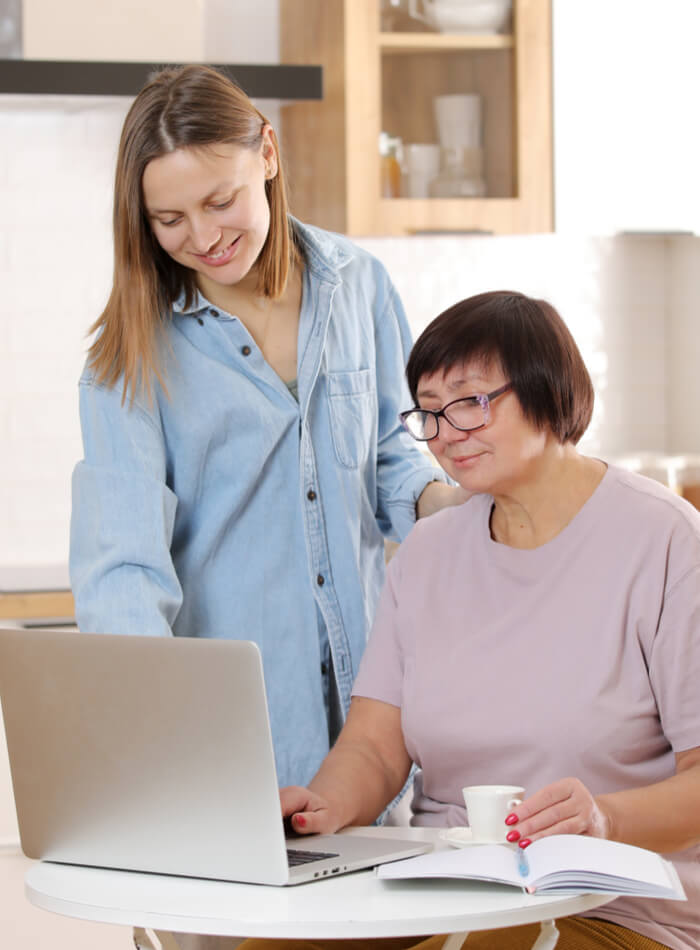 two women looking at a laptop