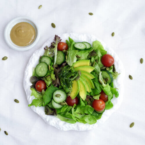 Japanese inspired Sesame Salad2 with sesame dressing in a small bowl on the side