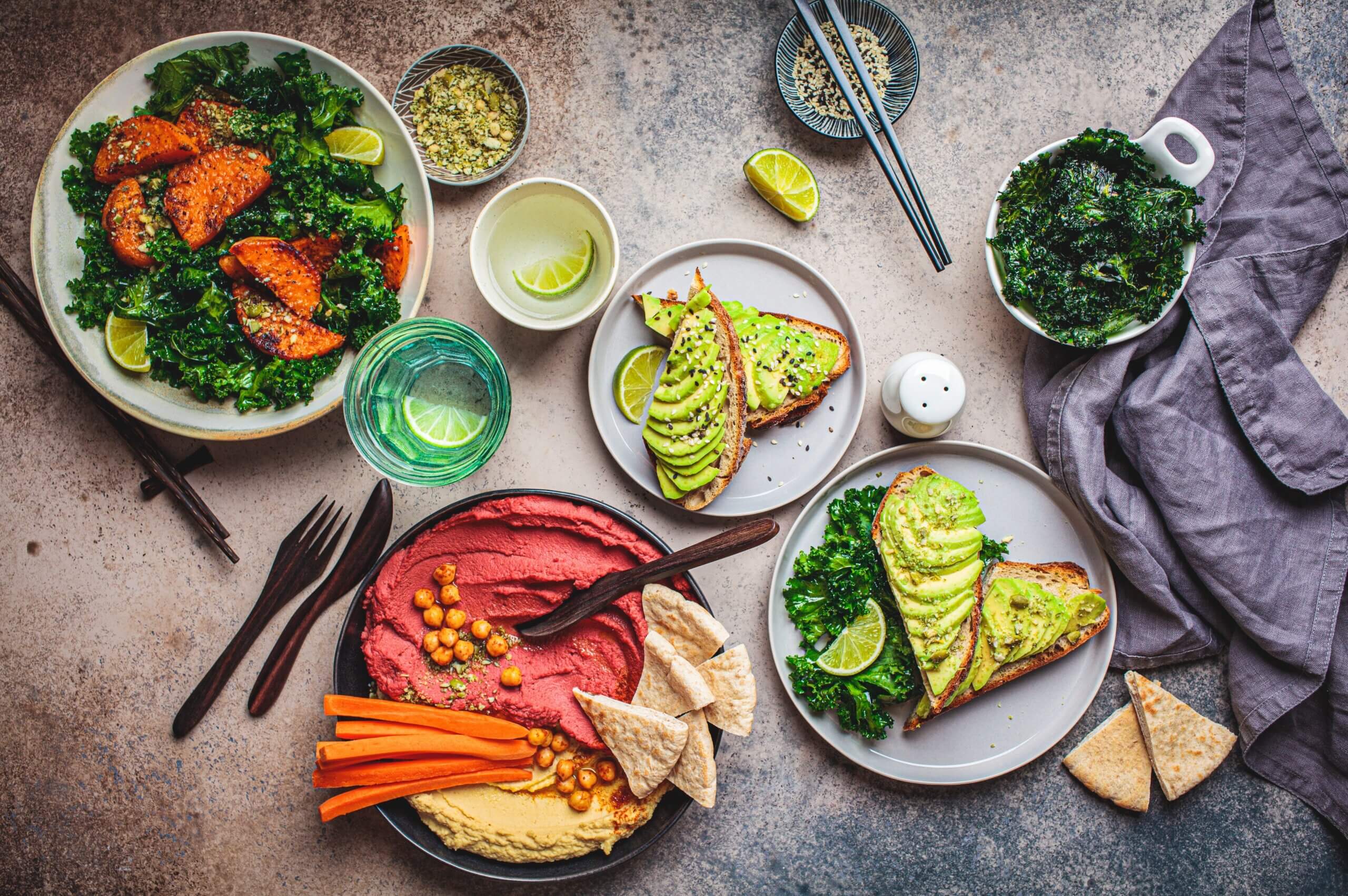 Spread of healthy food swaps including avocado toast, hummus with vegetables, and kale salad