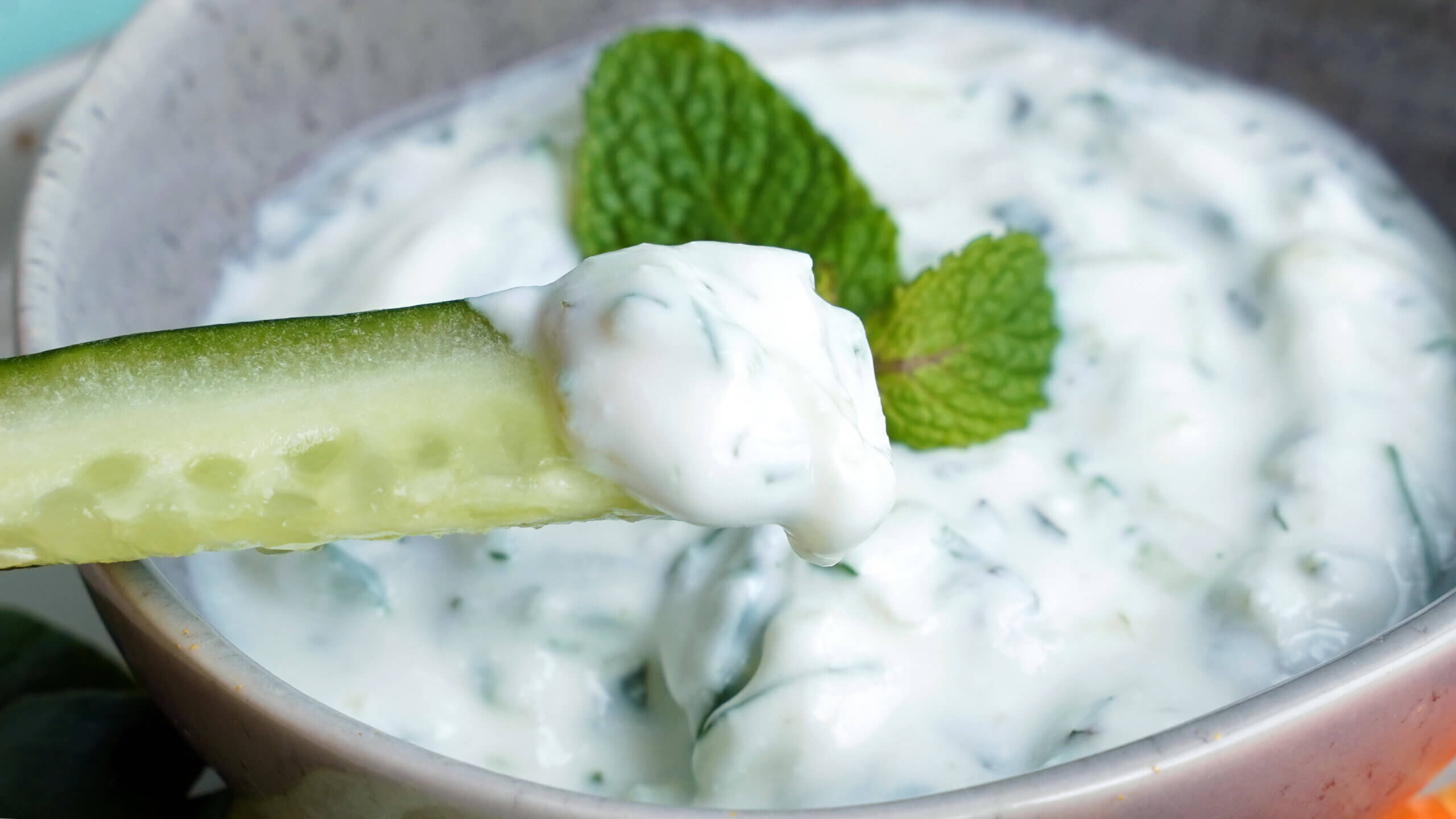 cucumber yogurt dip with cucumber stick closeup