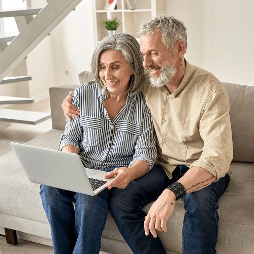 Couple smiling at computer during CKD class on kidney and renal nutrition for CKD, PKD and dialysis.